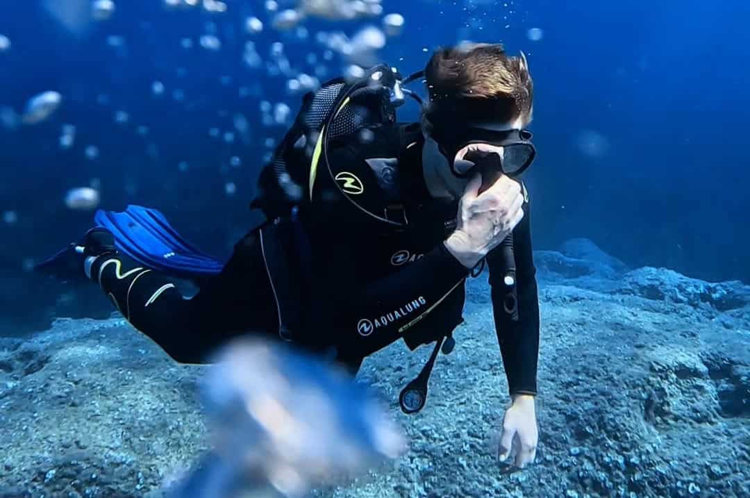 Diver equalizing ears during descent